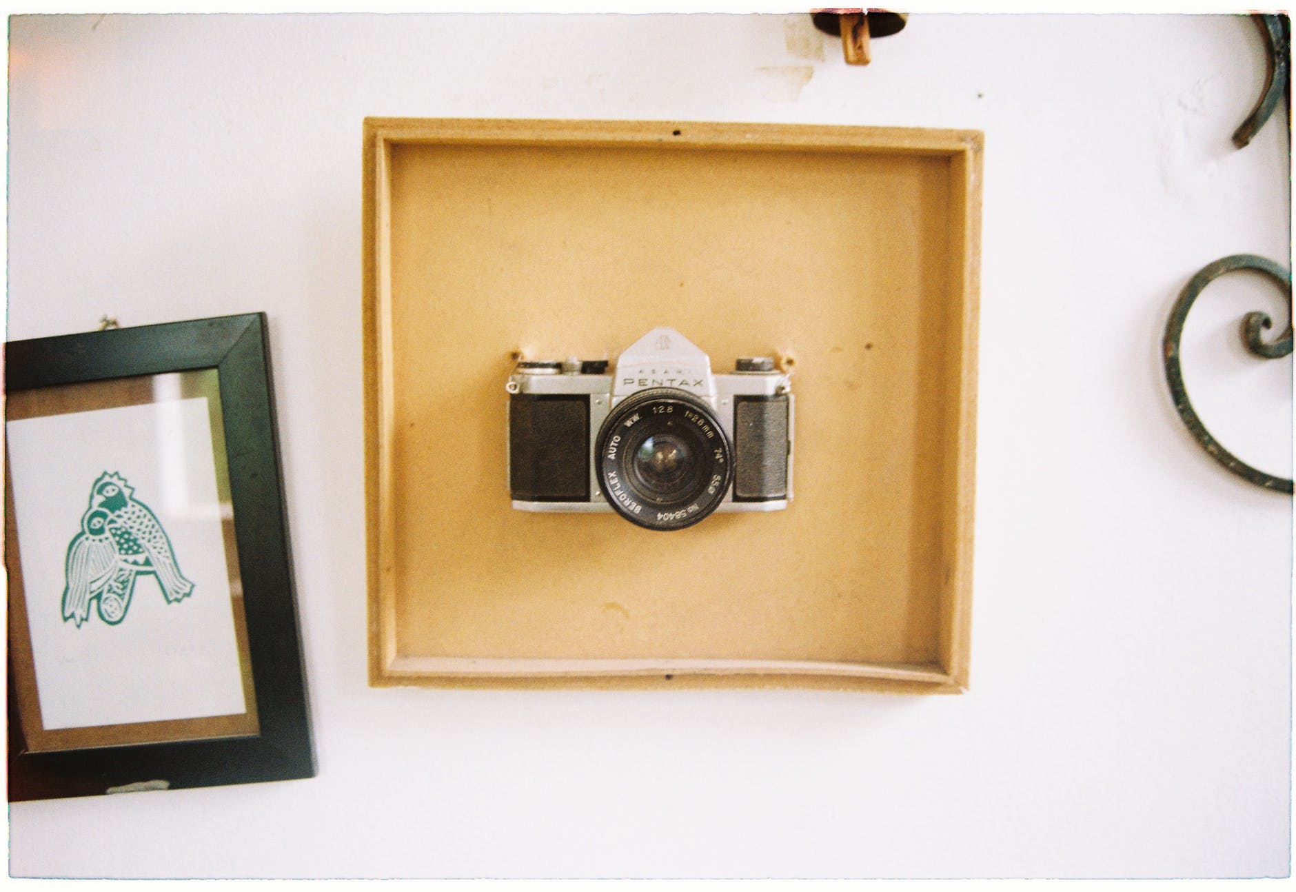 white and black camera inside a wooden frame